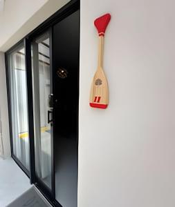 a wooden spatula hanging on a wall next to a door at Petit da Pipa Studios Privados in Pipa +97 photos