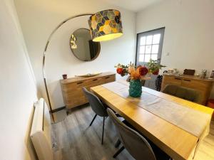 a dining room table with a vase of flowers on it at Maison Casa Nord du Portugal Gères in Arcos de Valdevez