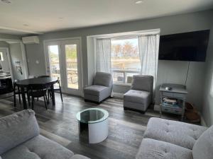 a living room with a couch and a table at Riverside Haven on Georgian Bay in Wasaga Beach