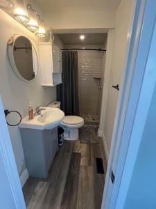 a bathroom with a white sink and a toilet at Riverside Haven on Georgian Bay in Wasaga Beach