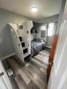 a bedroom with a bed and a staircase in it at Riverside Haven on Georgian Bay in Wasaga Beach