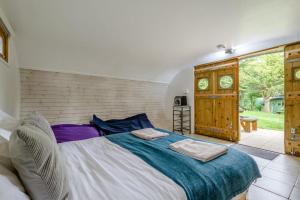 a bedroom with a large bed with two towels on it at 1 Bed in Bude oc-s34856 in Bude