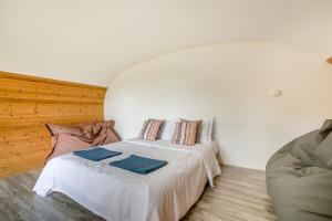 a bedroom with a bed and a couch at 1 Bed in Bude oc-s34852 in Bude