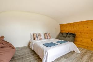 a bedroom with a white bed and a couch at 1 Bed in Bude oc-s34852 in Bude