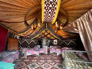 a room with beds and a ceiling with lights at Aruna Guesthouse in Saty