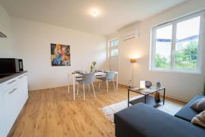 a living room with a couch and a table at Au 212, T2 moderne et confortable in Mont-de-Marsan