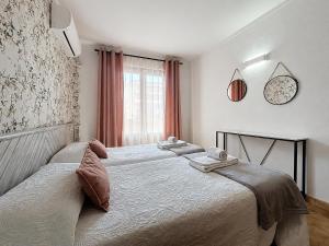 a bedroom with two beds and a window at BRESSOL DELUXE Apartments in Port de Pollensa +40 photos
