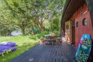 a wooden deck with a table and a picnic table at 1 Bed in Bude oc-s34849 in Bude