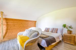 a room with a bed and a wicker chair at 1 Bed in Bude oc-s34849 in Bude +10 photos
