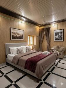 a bedroom with a large bed and a chair at Vaishno Atithi Bhawan in Naimishāranya