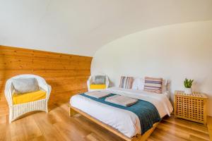 a bedroom with a bed and two chairs at 1 Bed in Bude oc-s34850 in Bude