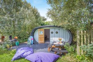 a backyard with a shed with a table and chairs at 1 Bed in Bude oc-s34847 in Bude