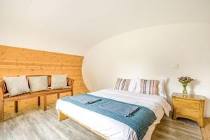 a bedroom with a bed and a bench in it at 1 Bed in Bude oc-s34847 in Bude