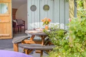 a wooden table with flowers on a patio at 1 Bed in Bude oc-s34847 in Bude