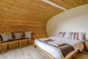 a bedroom with a bed and a wooden wall at 1 Bed in Bude oc-s34846 in Bude