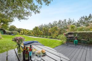 a table with food and drinks on a wooden deck at 1 Bed in Bude oc-s34846 in Bude