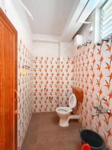 a bathroom with a toilet and a sink at Hotel Rajlaxmi in Neil Island