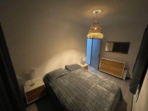 a bedroom with a bed and a blue door at Maison Casa Nord du Portugal Gères in Arcos de Valdevez