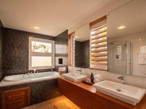 a bathroom with two sinks and a tub and a window at 3BR Beachfront Private Pool Ultravioleta Cabarete in Cabarete