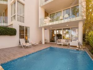 a large house with a swimming pool in a yard at 3BR Beachfront Private Pool Ultravioleta Cabarete in Cabarete