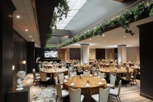 a banquet hall with tables and chairs in a room at Loews Nashville Hotel at Vanderbilt Plaza in Nashville