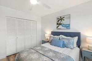 a bedroom with a bed with a blue headboard at Bright 2BR Oceanview Condo in Key West