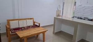 a wooden chair sitting in a room with a counter at Tranquil River Nest in Rupa