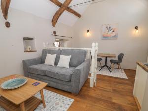 a living room with a couch and a table at Beudy Bach in Llanbedr