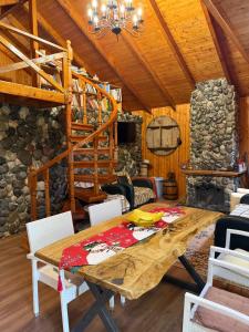 a dining room with a wooden table in a cabin at Vila Kadiu in Klos