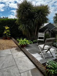 a patio with a chair and some plants at Barnfield house in Upham
