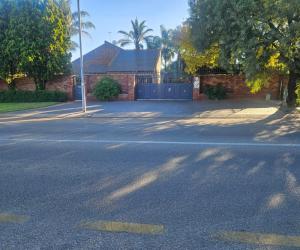 an empty street in front of a house at Oblique Boutique House in Centurion