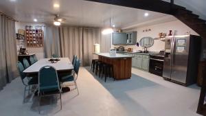 a kitchen with a table and chairs and a refrigerator at Casa Magnolia in El Socorro