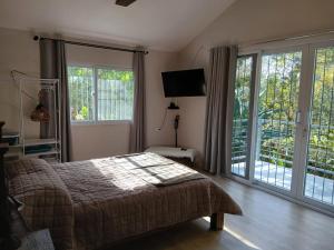 a bedroom with a bed and a large window at Casa Magnolia in El Socorro