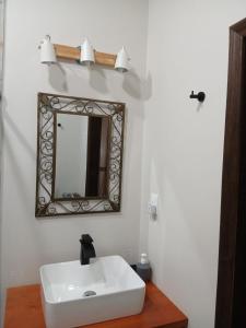 a bathroom with a white sink and a mirror at Casa Magnolia in El Socorro