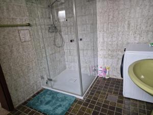 a shower with a glass door in a bathroom at Ferienzimmer-Monteurzimmer in Sibbesse +16 photos