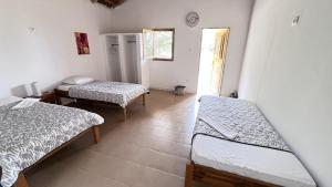 a room with two beds and a window at Vacaciones Timonier in Mar Lodj +3 photos