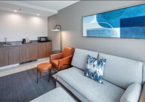 a living room with a couch and a chair at Courtyard by Marriott Conway in Conway