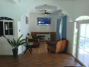 a living room with two chairs and a fireplace at Casa chalet in Chiquimula
