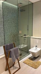 a bathroom with a sink and a toilet and a shower at Home Sweet Home in Abu Dhabi +63 photos