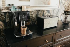 a coffee machine sitting on a counter with a cup at Simply rooms in Slavkov u Brna