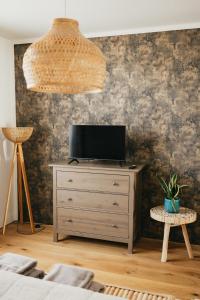 a room with a dresser with a television on it at Simply rooms in Slavkov u Brna