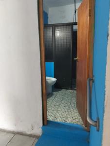 a door to a bathroom with a toilet in it at Tu hogar en tapachula in La Concepción