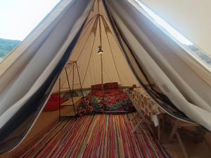 a tent with a bed in the middle at El Astial De Ezquerra - Camp in Ezquerra