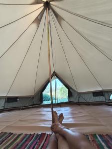 a person is holding onto a large umbrella at El Astial De Ezquerra - Camp in Ezquerra +13 photos