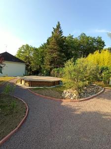 a winding driveway with a pavilion in a garden at Le nid des mésanges in Veigné
