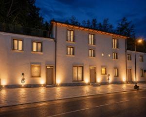 a large white building at night with lights at Fenisien Boutique Rooms in Contursi