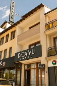a building with a sign for a hotel at DejaVu Hotel in Prizren