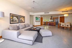 a living room with a couch and a table at Luxury 3BR Beachfront Private Pool Ultravioleta in Cabarete