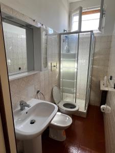 a bathroom with a sink and a toilet and a shower at La dolce casa in Verdellino
