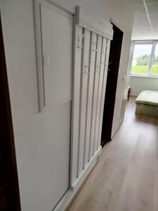 a room with a hallway with doors and a window at Apartmán Lhota in Náchod